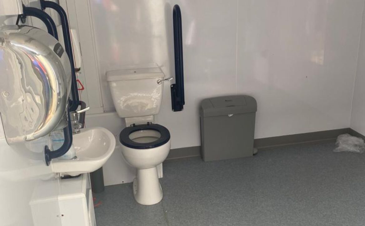 Picture of the accessible toilet and sink equipped with hand rails and pliantly of space to turn a wheelchair